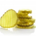 Sliced pickles showcasing their acidic nature, highlighting unexpected foods harmful to dental health.
