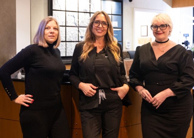 Administrative team members at Water Tower Dental Care, showcasing professionalism and approachability, standing together in a modern dental office setting.